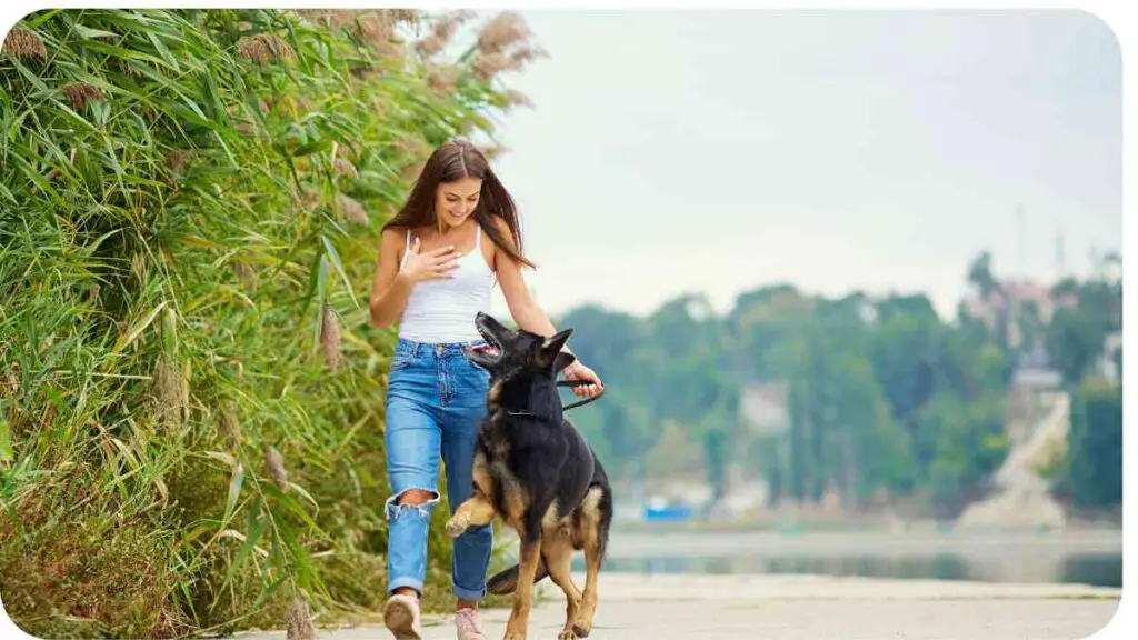 a person is walking with their dog by the river