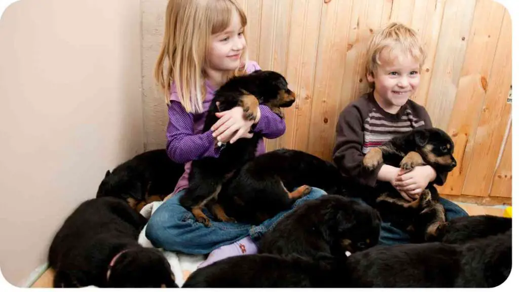 two children sitting on the floor holding puppies